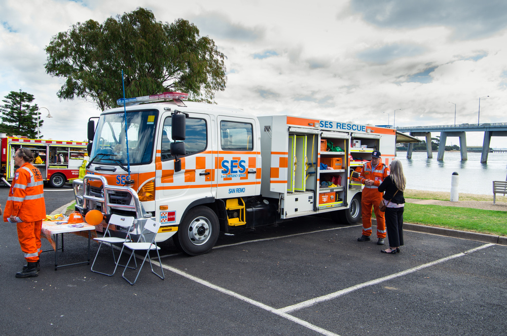 Group of emergency workers around an SES rescue vehicle Group of emergency workers around an SES rescue vehicle